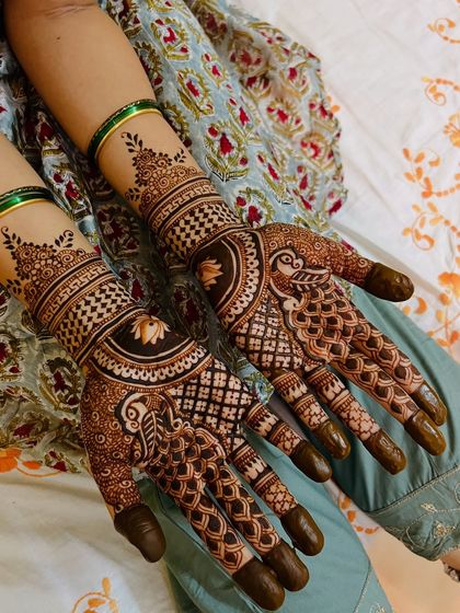 A beautiful semi-bridal design with peacocks and lotus motifs, perfect for an engagement or sangeet.