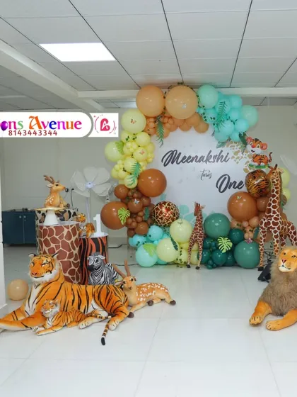 A wide shot of a jungle animal theme for Meenakshi's first birthday. I used large, realistic props of a tiger, lion, and deer to create an exciting and immersive environment for the kids.