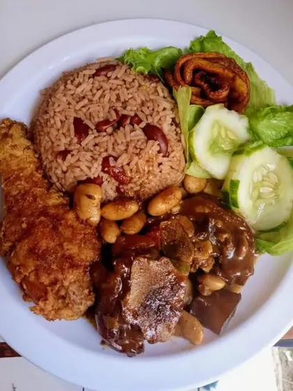 A hearty and wholesome meal plate with fried chicken, rice and beans, and a side of salad. We can cater to a variety of international cuisines.
