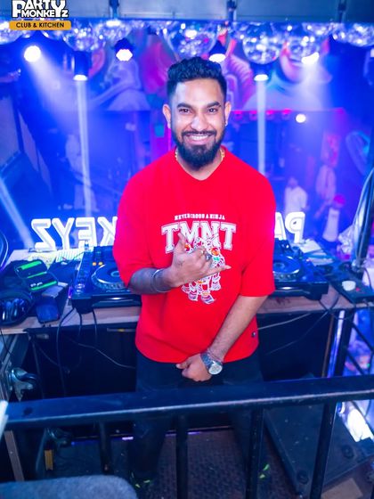 A smile from the DJ booth at Party Monkeyz. It's all about good vibes and connecting with the people on the dance floor, making sure everyone has an unforgettable night.