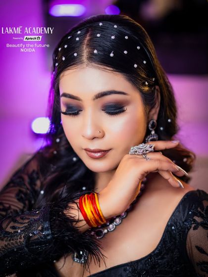 A close-up on the dark, smokey eye makeup and the pearl-studded hairstyle, a perfect combination for a glamorous evening.