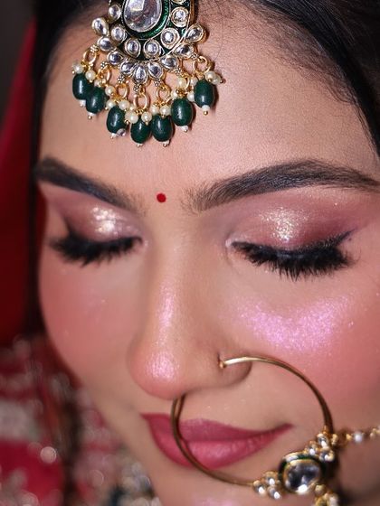 A detailed close-up of the eye makeup. You can see the soft pink shimmer on the lids, the clean eyeliner, and the perfectly groomed brows.