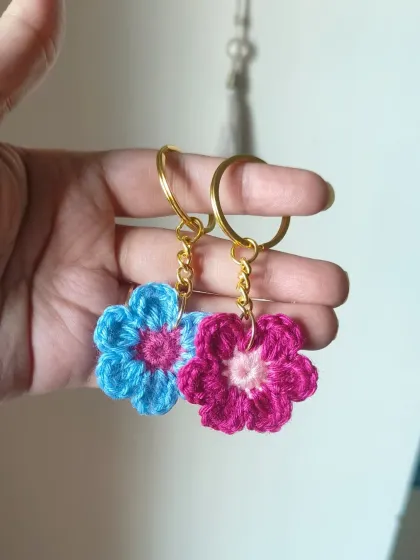 We offer our floral keychains in many color combinations. This pair shows a blue and pink one next to a magenta and pink one, perfect for coordinating with friends.