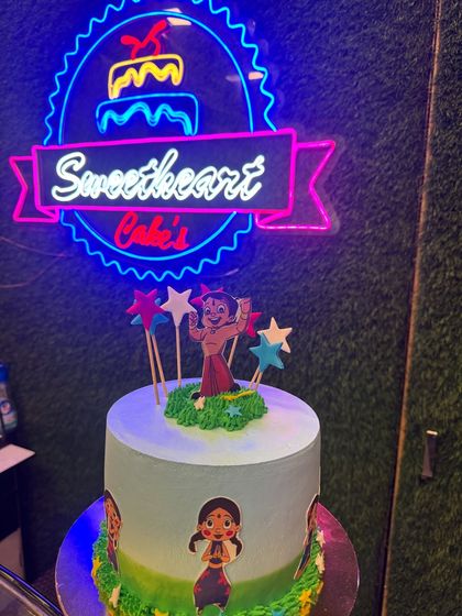 This Chhota Bheem cake brings the popular Indian cartoon character to the party. Set against my bakery's neon sign, it shows how I can create any character your child loves.