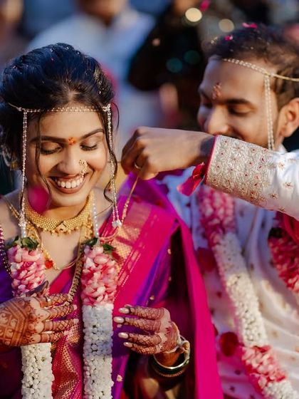 The groom tying the mangalsutra, a key moment in a Maharashtrian wedding.