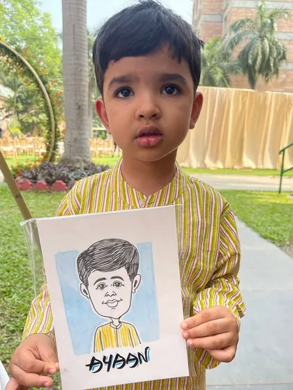 Even the youngest guests enjoy getting their caricature done. This little boy was thrilled with his portrait at a recent wedding, complete with a touch of colour.