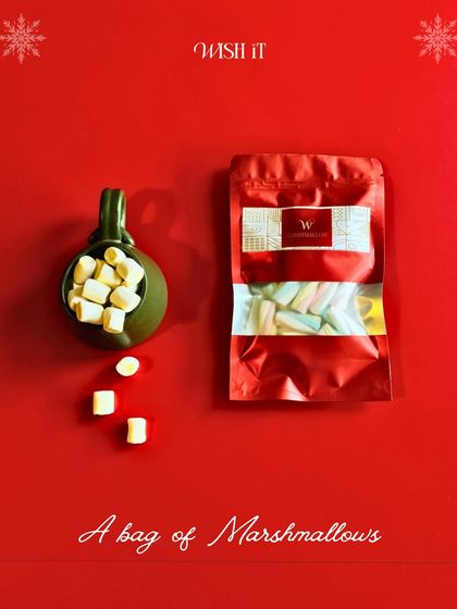 A cozy shot of a festive mug filled with marshmallows, a key component of our Holiday Crate for those curl-up-by-the-fire moments.