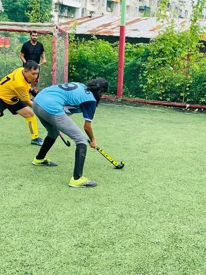 A female player shows great technique as she battles for the ball against a male opponent, highlighting our inclusive training environment.