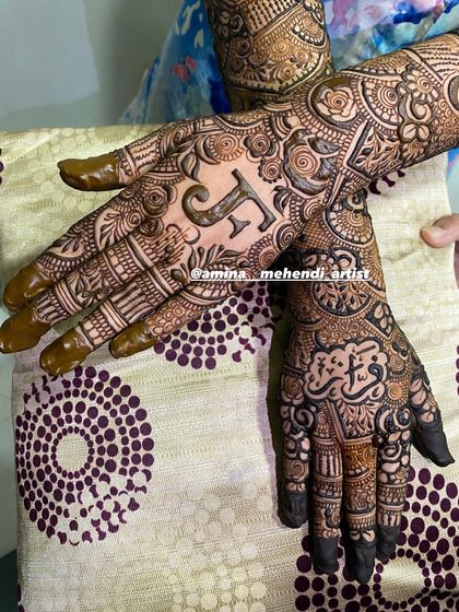 A close-up of the palms, showing the initial 'F' and the name 'Fiza' in Arabic script.