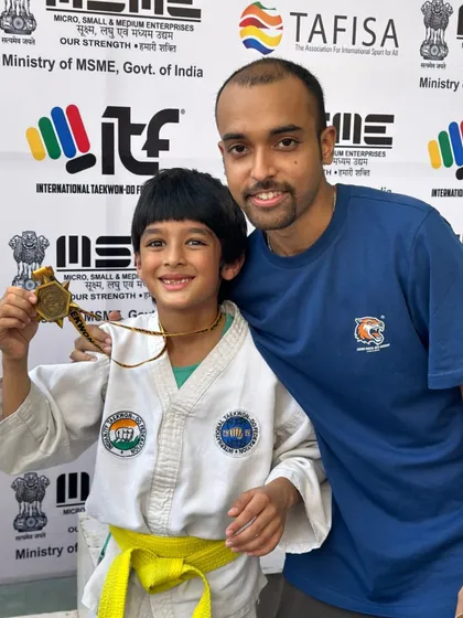 A young champion showing off his gold medal. It's a joy to coach kids and see them achieve their goals with a smile.