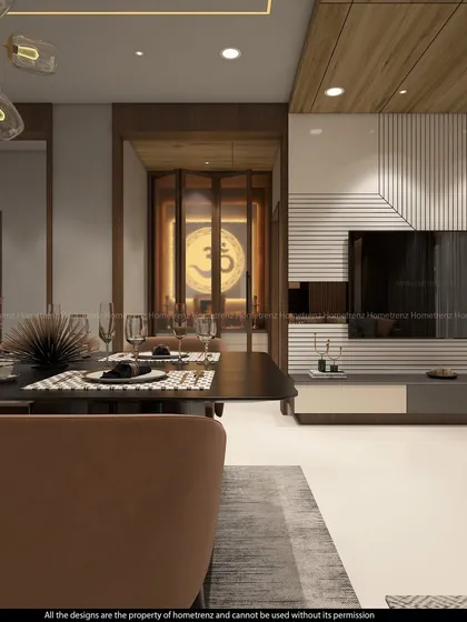 A view from the dining area towards the pooja room. The foldable glass door with an 'Om' symbol creates a sense of sanctity while allowing the space to feel connected to the rest of the home.