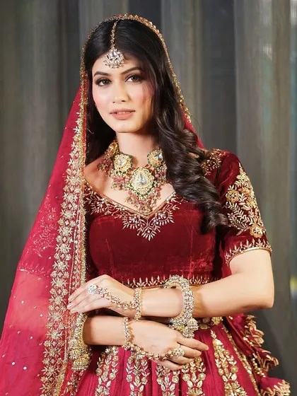 A portrait of our beautiful bride in her velvet lehenga. The makeup is soft and timeless, allowing her natural beauty and the rich outfit to shine.