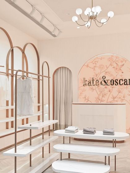 This shot captures the welcoming entrance of the boutique. The combination of the curved counter, arched displays, and soft lighting creates an immediate impression of elegance and calm.