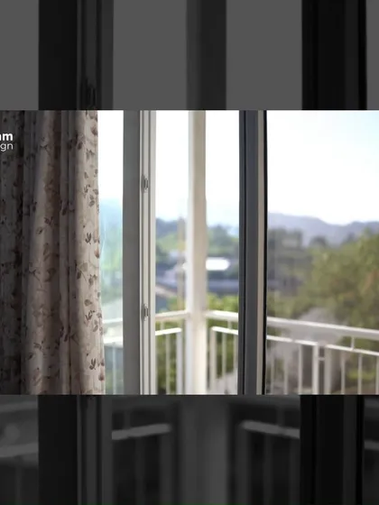 A glimpse of the stunning valley view from one of the farmhouse windows, framed by simple curtains. Every opening in the house was carefully placed to capture the beauty of the surrounding tea estates.