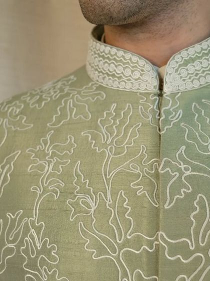 A closer look at the delicate dori work and the detailed embroidery on the collar, showcasing our signature craftsmanship.