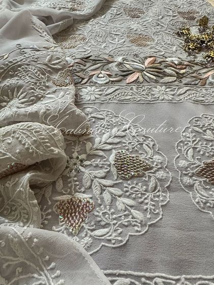 A draped view of the suit, showing the texture of the georgette and the detailed embroidery on the dupatta.