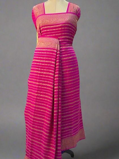A mannequin draped in a beautiful pink pure Banaras crepe saree with stripes.