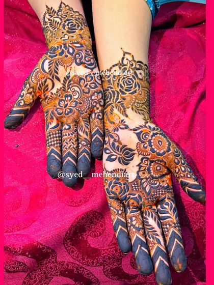 A stylish design with bold chevron patterns on the fingers and a mix of florals on the palms.