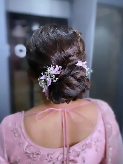 A back view of the mother of the bride's beautiful floral bun.