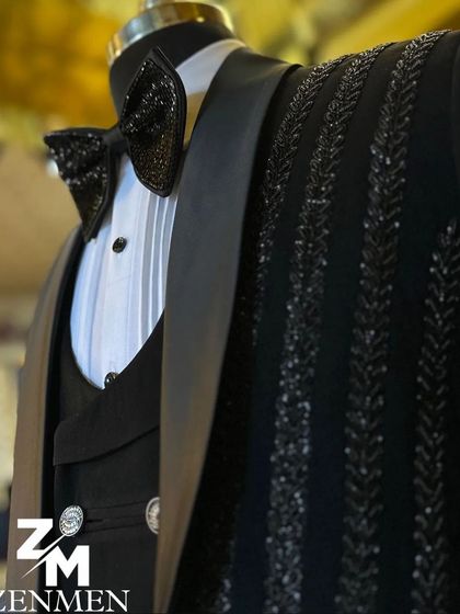 A close-up of the sparkling bow tie and lapel of the vertically striped tuxedo. The attention to detail ensures a polished and luxurious look.