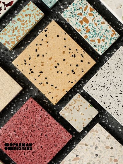 A flat lay of our terrazzo tile samples, showcasing a variety of colors and aggregate sizes. From bold reds to subtle yellows and classic whites, the possibilities are endless.