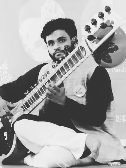 A black and white portrait capturing the serious dedication required for classical music. It reflects the years of riyaaz and devotion to the art.