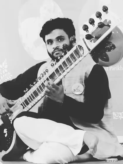 A moment of performance, seated on stage. This traditional posture helps in maintaining balance and control over the instrument.