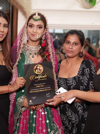 Graduation day is a team effort. Here with my staff, presenting a certificate to a talented student.