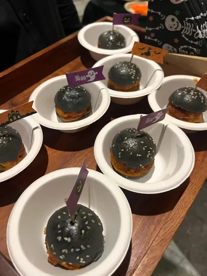 For a Halloween party, we created these spooky mini sliders with activated charcoal buns. It's a fun example of how we can customize our menu to fit any party theme.