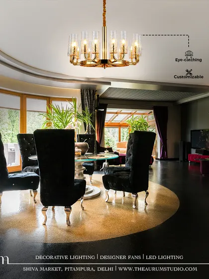 In this dramatic dining room, a customizable gold and crystal chandelier serves as an eye-catching centerpiece. Its design elevates the high-contrast decor, turning every meal into a luxurious event.