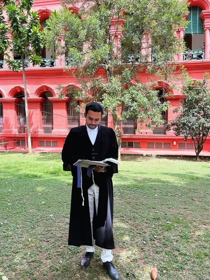 Preparing for a case outside the iconic red building of the High Court of Karnataka. Thorough preparation and a deep dive into case law are fundamental to my practice.