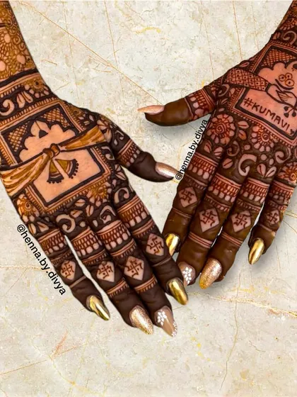 A closer look at the intricate details of a bridal back-hand design. You can see the doli, the "Kumavi" text, and the fine floral and geometric patterns that fill the hand.