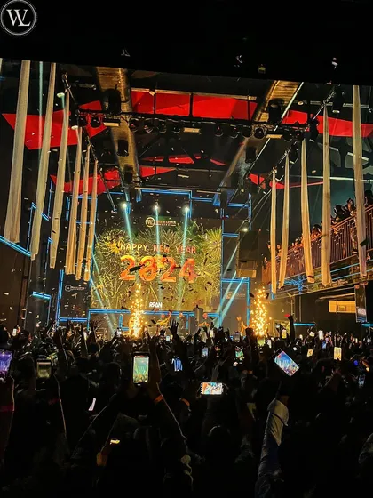 A wide shot of the New Year 2024 countdown. This photo captures the scale of the celebration and the excitement of the massive crowd.