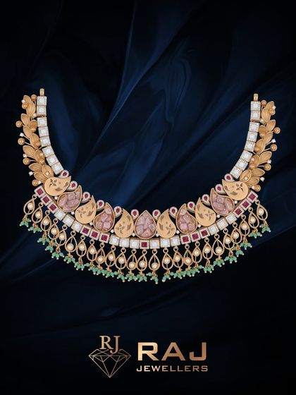 This beautiful Revaj necklace features a cascade of paisley motifs crafted with pink stones and polki. The delicate drops of green beads and pearls add movement and grace to this classic, feminine design.