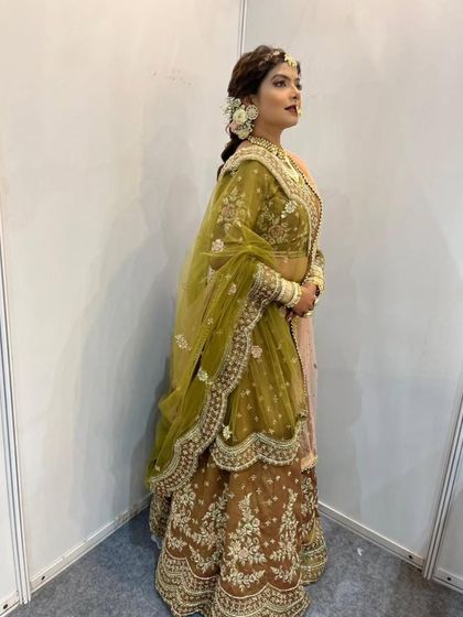 I love offering unique colour combinations like this mehndi green and brown lehenga. The rich embroidery and dual-tone dupatta create a distinctive and elegant bridal look, perfect for a daytime or evening wedding ceremony.