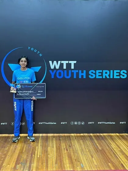 Yashaswini posing with her winner's check and trophy at the WTT Youth Series in Ecuador.