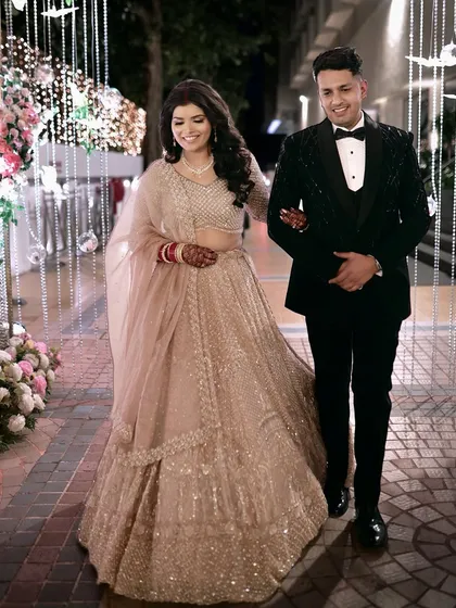 My reception bride and her groom making their grand entrance. Her minimal, glossy makeup ensures she looks fresh and radiant all evening long.