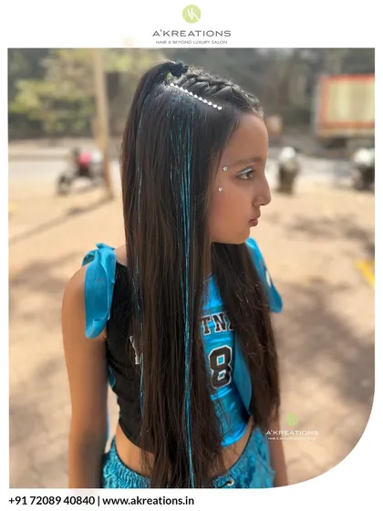 Styling is for all ages. We created this trendy look for a young client, featuring cool double braids, sparkling hair accessories, and a touch of face glitter.
