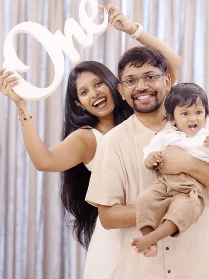 A fun and playful family portrait to celebrate their son's first birthday. The 'One' sign adds a celebratory touch to this happy memory.