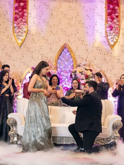 The classic proposal, with the groom on one knee, surrounded by smoke and the applause of their families.