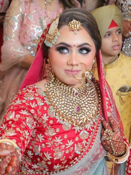 A candid moment during the wedding. The makeup looks fresh and radiant, capturing her natural beauty and happiness.