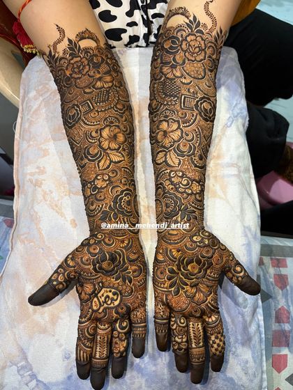 A full bridal design with a focus on roses and intricate fill-work, creating a rich and luxurious look.