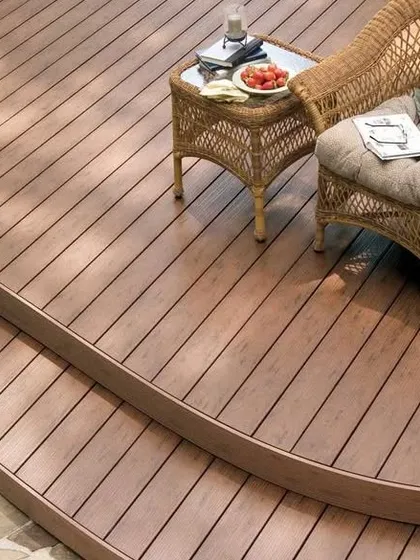 A curved, multi-level deck made from composite wood. The smooth, rounded edges create a soft, organic flow and demonstrate our ability to create complex, custom shapes.