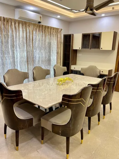 A full view of a grand dining set. The table is paired with chairs that feature a high-gloss wood finish and brass inlay, creating a cohesive and luxurious environment for formal dining.