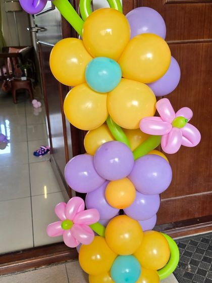 A close-up of a balloon flower column, showing the creative twisting technique used to create detailed shapes.