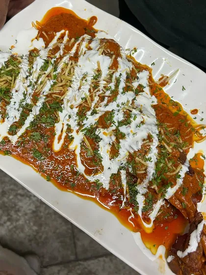 Our Mutton Tandoori Sauce Bawra, a show-stopping dish for special occasions. The tender mutton is drenched in a rich, tangy sauce and garnished beautifully.