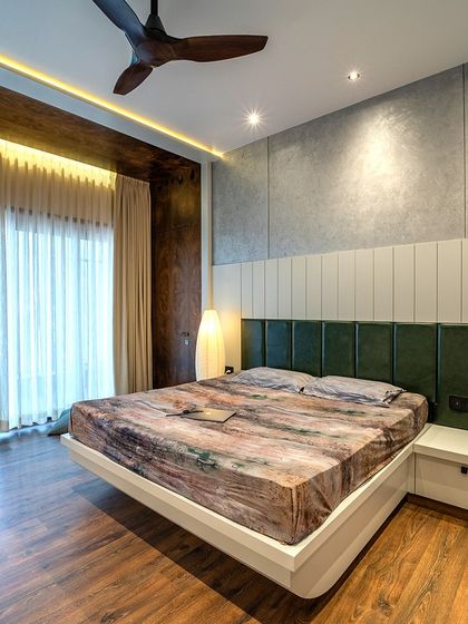 Another angle of the master bedroom, highlighting the wooden flooring and the seamless integration of the balcony.