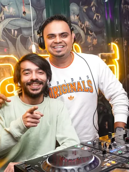 Sharing a smile with a fellow artist behind the decks. The camaraderie and mutual respect in the DJ community is one of the best parts of the job.
