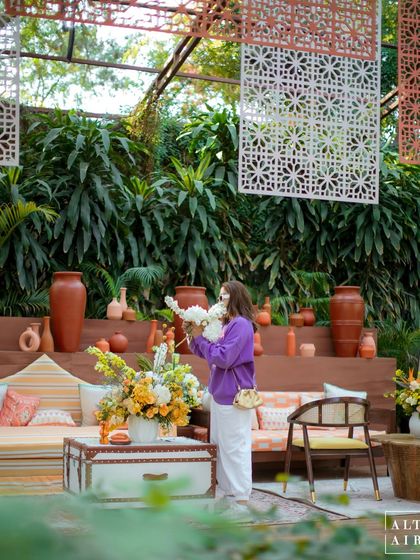 A behind-the-scenes moment of me arranging flowers at the 'Kesar Sehar' Haldi. The design blended traditional florals and handcrafted artifacts with modern installations.