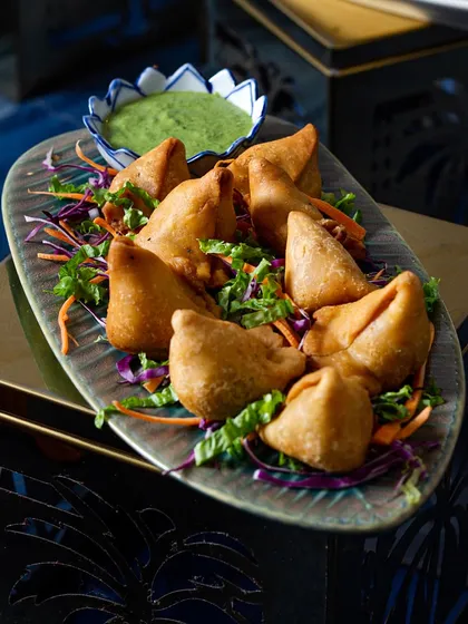 The classic mini samosa is a staple of Indian snacking. I serve them hot and fresh with tangy chutney, making them the perfect bite-sized snack for any occasion.